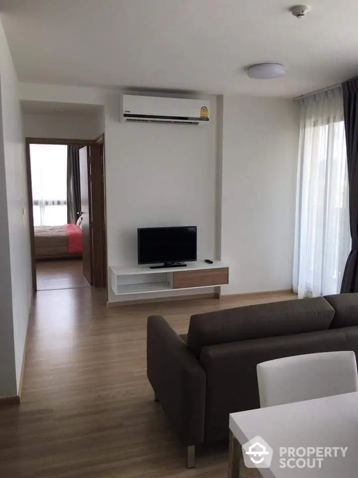 Modern living room with sleek furniture and natural light in a stylish apartment.