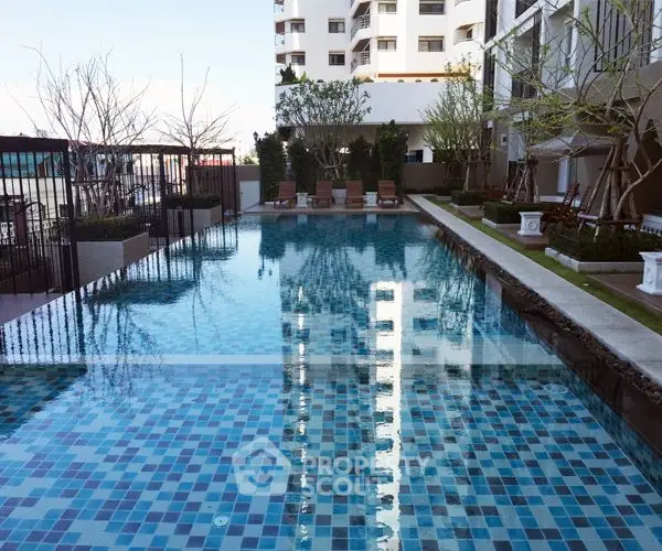 Luxurious condominium pool area with modern design and serene ambiance.
