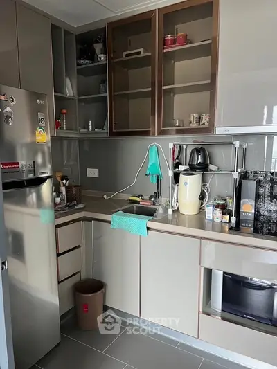 Modern kitchen with sleek cabinets and appliances, featuring a compact and efficient layout.