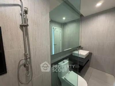 Modern bathroom with sleek fixtures and large mirror