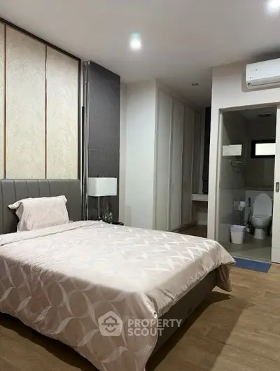 Modern bedroom with ensuite bathroom and sleek design.