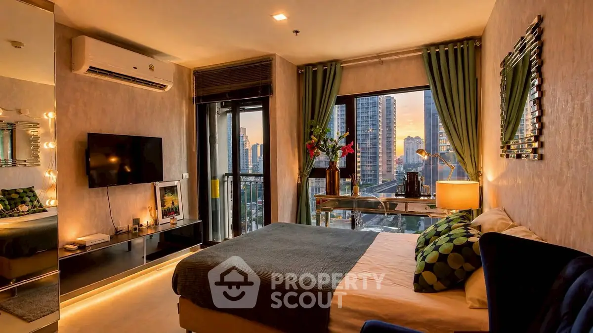 Luxurious bedroom with city view, modern decor, and stylish furnishings in a high-rise apartment.