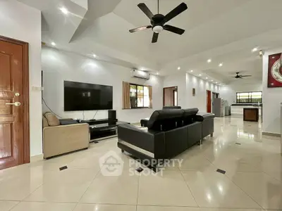 Spacious modern living room with sleek furniture and open layout, perfect for entertaining.