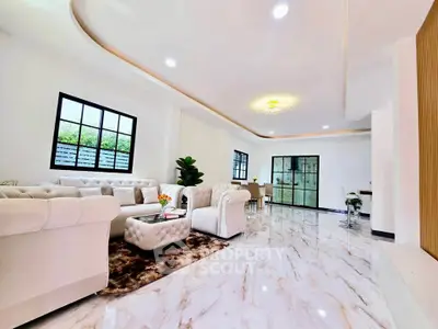 Luxurious open-plan living room with elegant furniture and marble flooring, perfect for modern living.