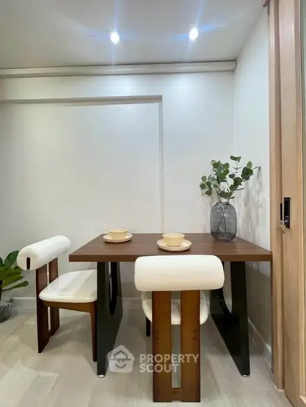 Modern dining area with stylish wooden table and chairs, perfect for cozy meals.