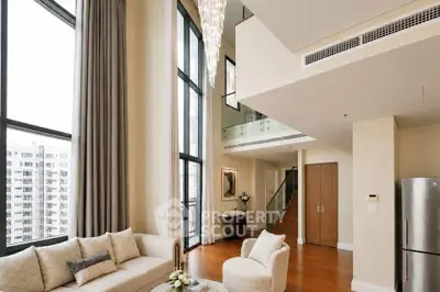 Luxurious high-ceiling living room with elegant decor and large windows in modern apartment