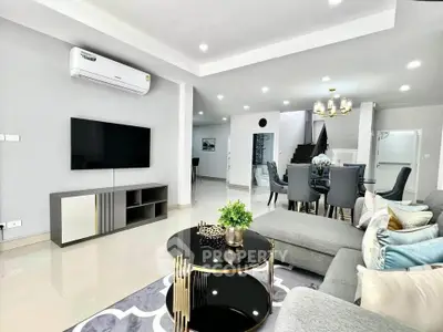 Modern living room with stylish decor and open dining area in a contemporary home.