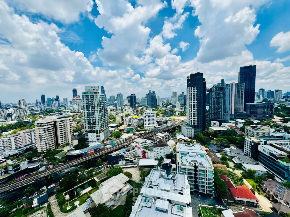 Stunning cityscape view showcasing modern skyscrapers and vibrant urban landscape under a bright blue sky.