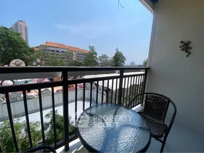 Charming balcony with city view, perfect for relaxation and outdoor dining.