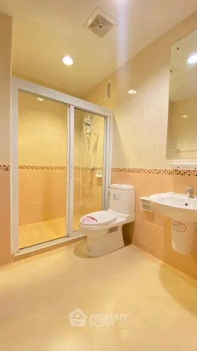 Modern bathroom with shower and sleek fixtures in a stylish apartment.
