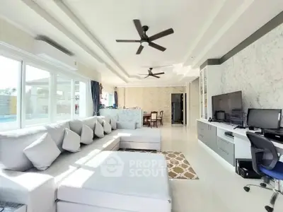 Spacious modern living room with large sectional sofa and ceiling fans
