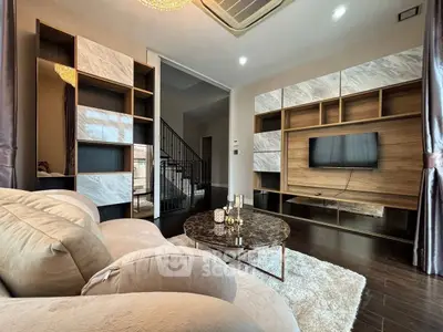 Luxurious living room with modern decor and elegant shelving, perfect for relaxation and entertainment.