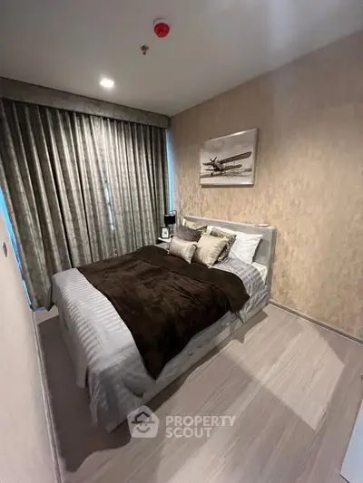 Cozy bedroom with modern decor and plush bedding in a stylish apartment.