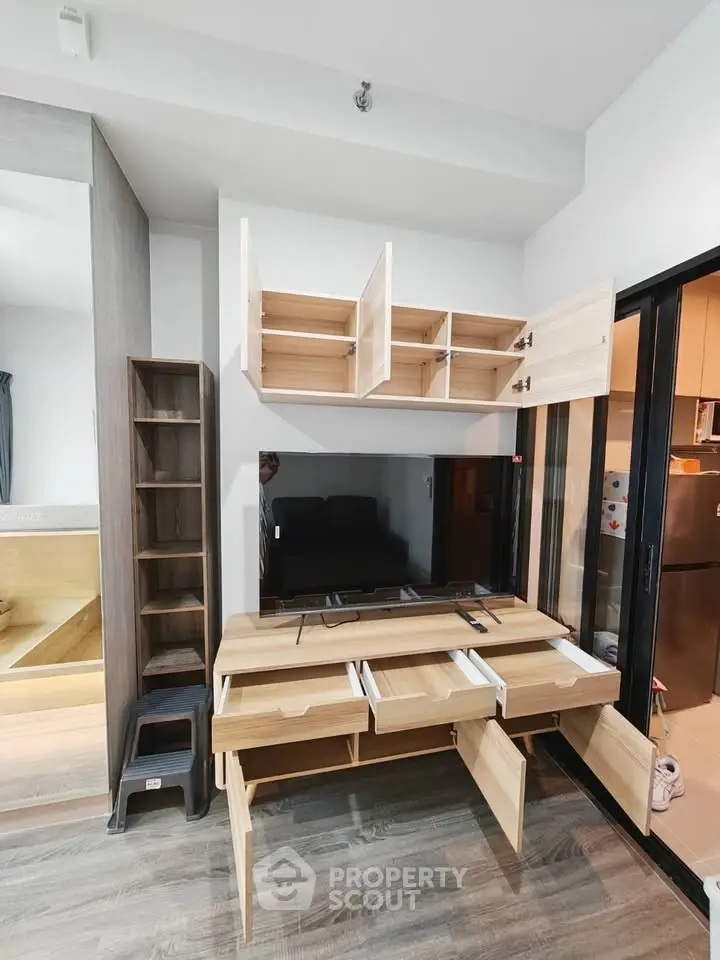 Modern living room with stylish wooden cabinetry and sleek TV setup