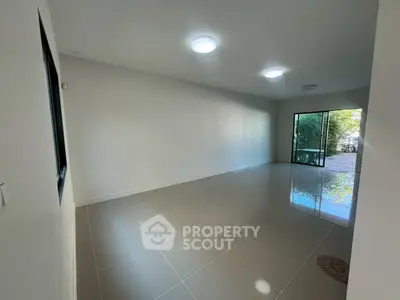 Spacious empty living room with large windows and garden view