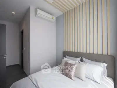 Modern bedroom with stylish decor and air conditioning unit