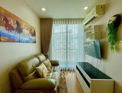 Cozy living room with leather sofa, wall-mounted TV, and large window with city view.