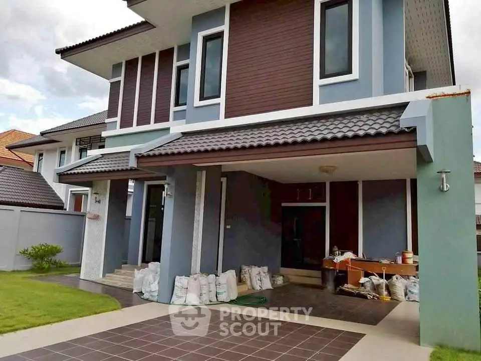 Modern two-story house with tiled driveway and landscaped lawn