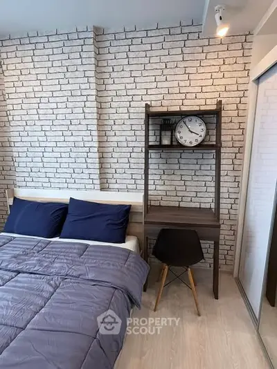 Modern bedroom with brick accent wall and cozy workspace