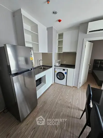Modern kitchen with sleek appliances and open layout in stylish apartment