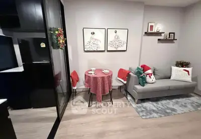 Cozy living room with festive decor and modern kitchen area