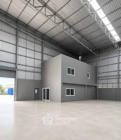 Spacious industrial warehouse with high ceilings and modern design, perfect for storage or manufacturing needs.
