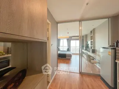 Modern apartment interior with open layout, featuring a cozy bedroom and stylish living area with wooden flooring.