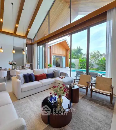 Luxurious living room with high ceilings and pool view in modern villa