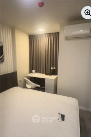 Cozy bedroom with modern decor and air conditioning unit, ideal for comfort and relaxation.