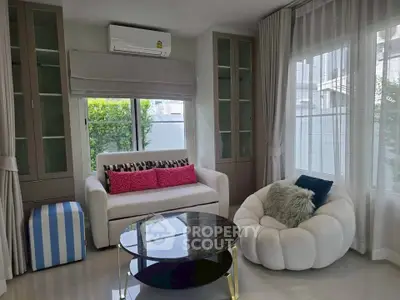 Chic living room with modern furniture and large windows for natural light.
