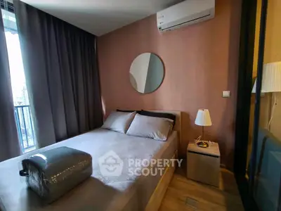 Modern bedroom with air conditioning and balcony view in urban apartment