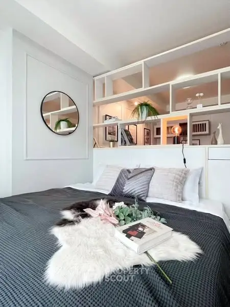 Stylish bedroom with modern decor and cozy bedding in a contemporary apartment.