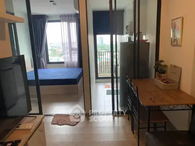 Modern studio apartment with balcony and city view, featuring a cozy living area and stylish decor.