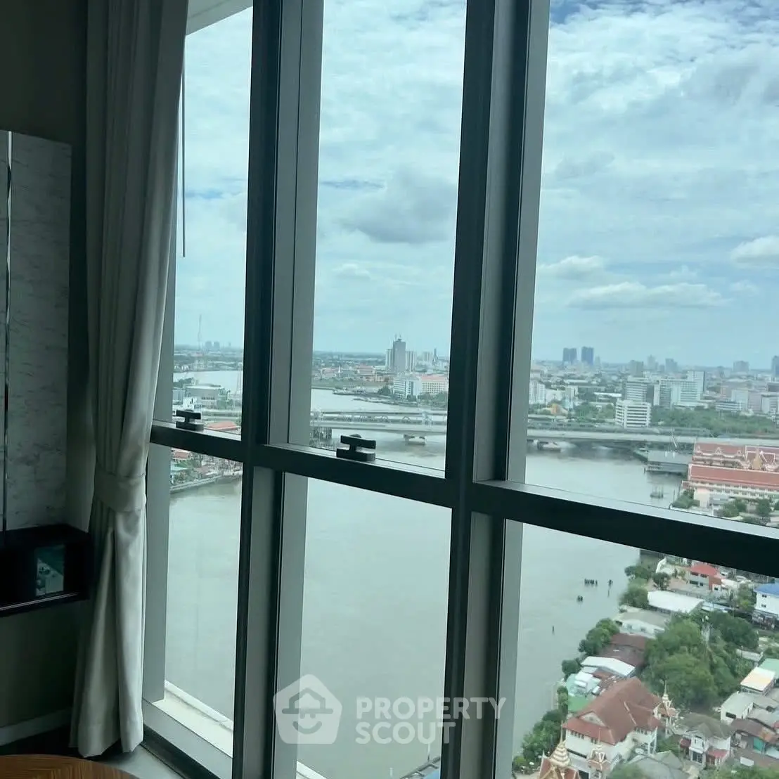 Stunning high-rise apartment with panoramic river and city views.