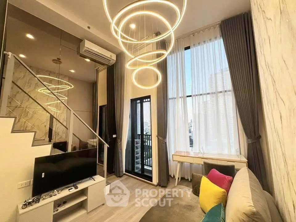 Modern living room with high ceilings and stylish lighting in a luxury apartment.