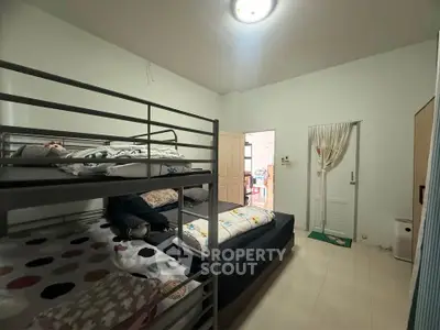 Cozy bedroom with bunk bed and minimalist decor, perfect for small families or shared living spaces.