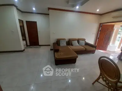 Spacious living room with cozy sectional sofa and elegant wooden accents