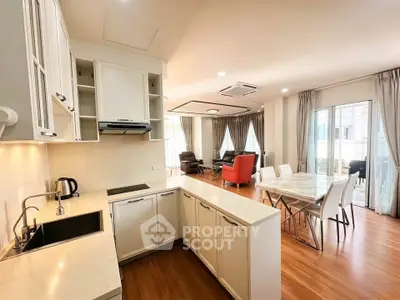 Spacious open-layout kitchen and living area with modern furnishings and natural light.