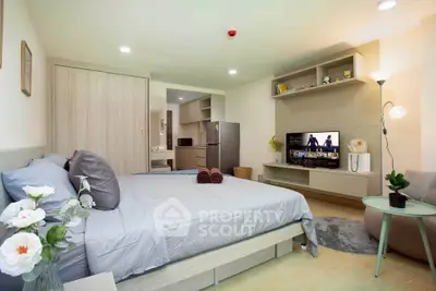 Modern bedroom with stylish decor and open layout, featuring a cozy bed and entertainment area.