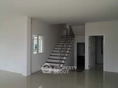 Spacious modern interior with sleek staircase and glossy tiled floors
