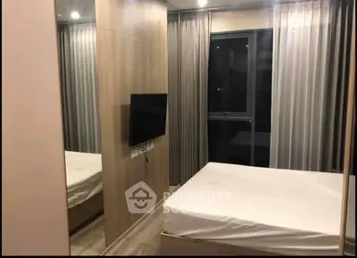 Modern bedroom with sleek design and wall-mounted TV