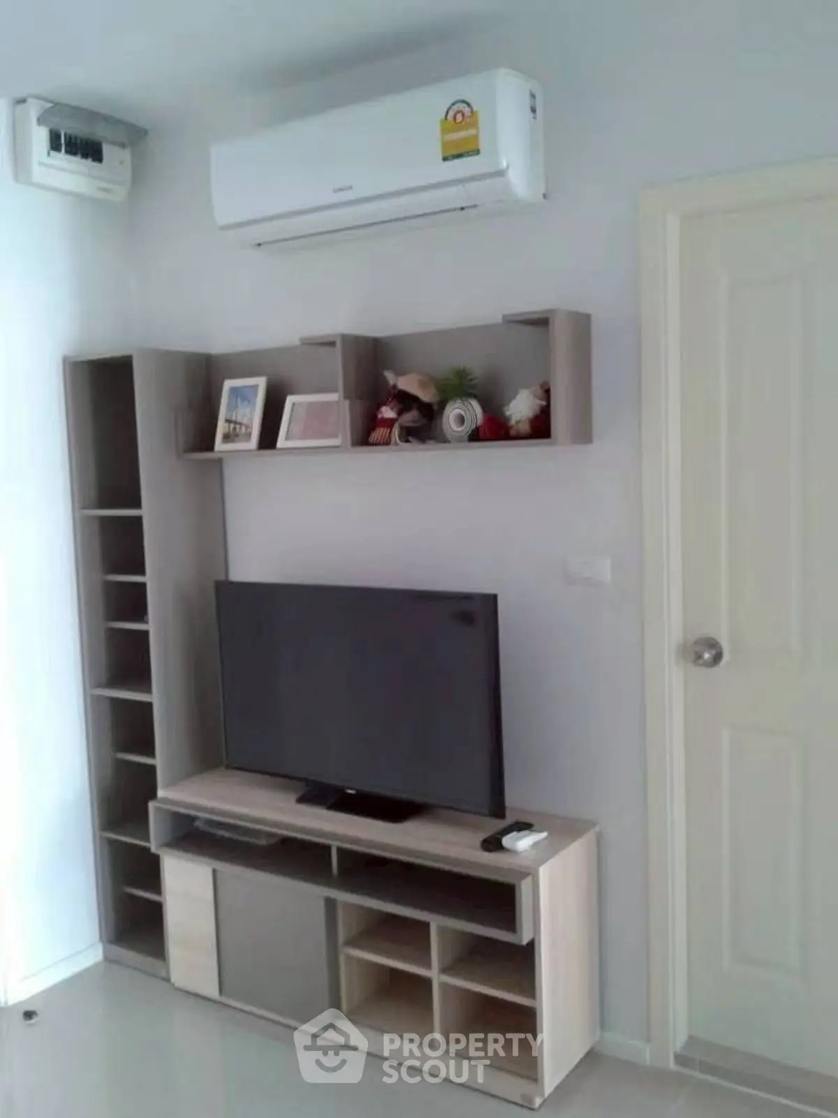 Modern living room with sleek TV stand and wall-mounted air conditioner