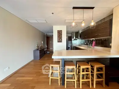 Modern open kitchen with wooden stools and sleek design