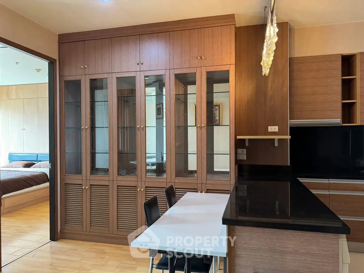 Spacious kitchen with wooden cabinets and modern dining area