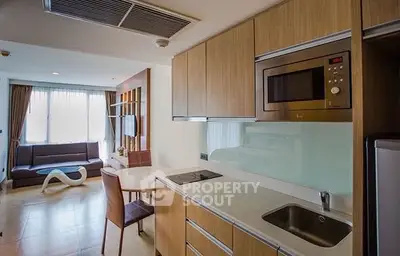 Modern open-layout kitchen with sleek appliances and cozy living area