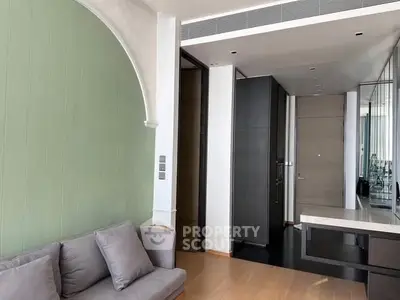 Modern living room with elegant green accent wall and cozy gray sofa