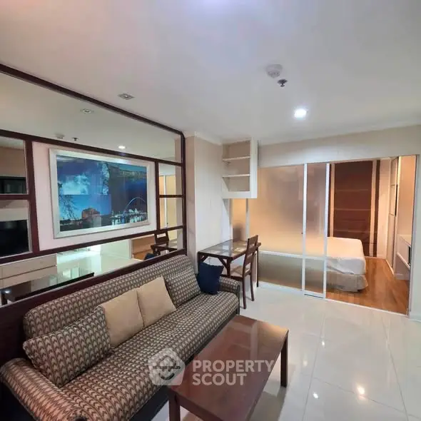Modern living room with stylish furniture and open view to bedroom, perfect for urban living.