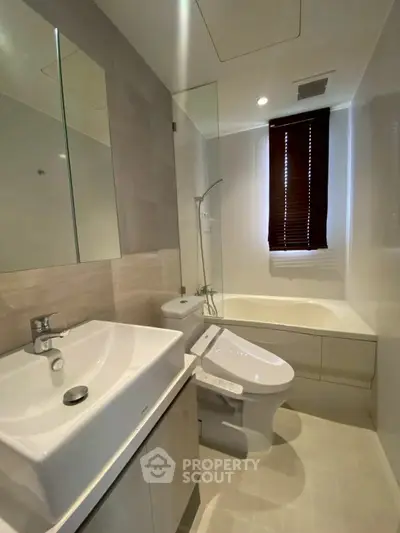 Modern bathroom with sleek fixtures and bathtub in contemporary apartment.
