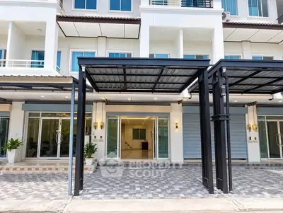 Modern townhouse exterior with covered parking and large glass doors.