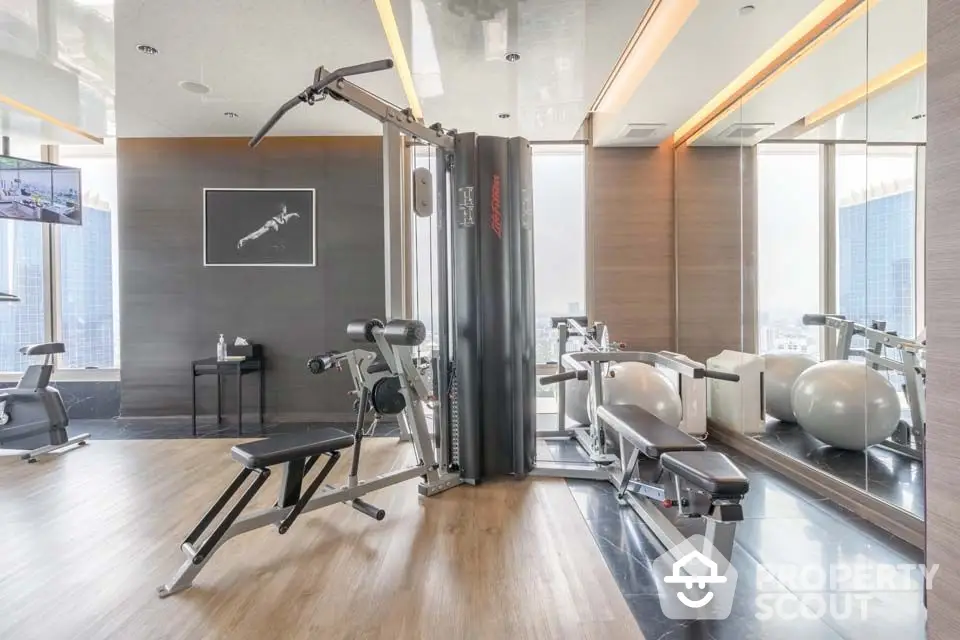 Luxurious modern gym with state-of-the-art equipment and mirrored walls in high-rise building.